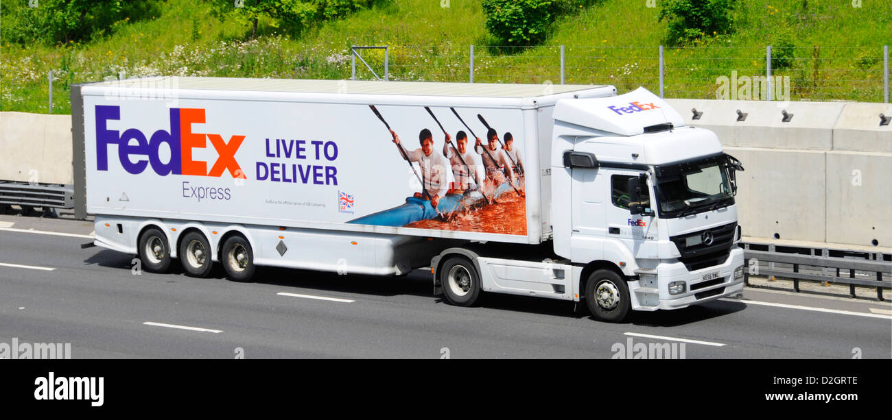 FedEx hgv truck with partnership graphics on articulated trailer supporting GB canoeing Mercedes Benz lorry on M25 motorway Stock Photo