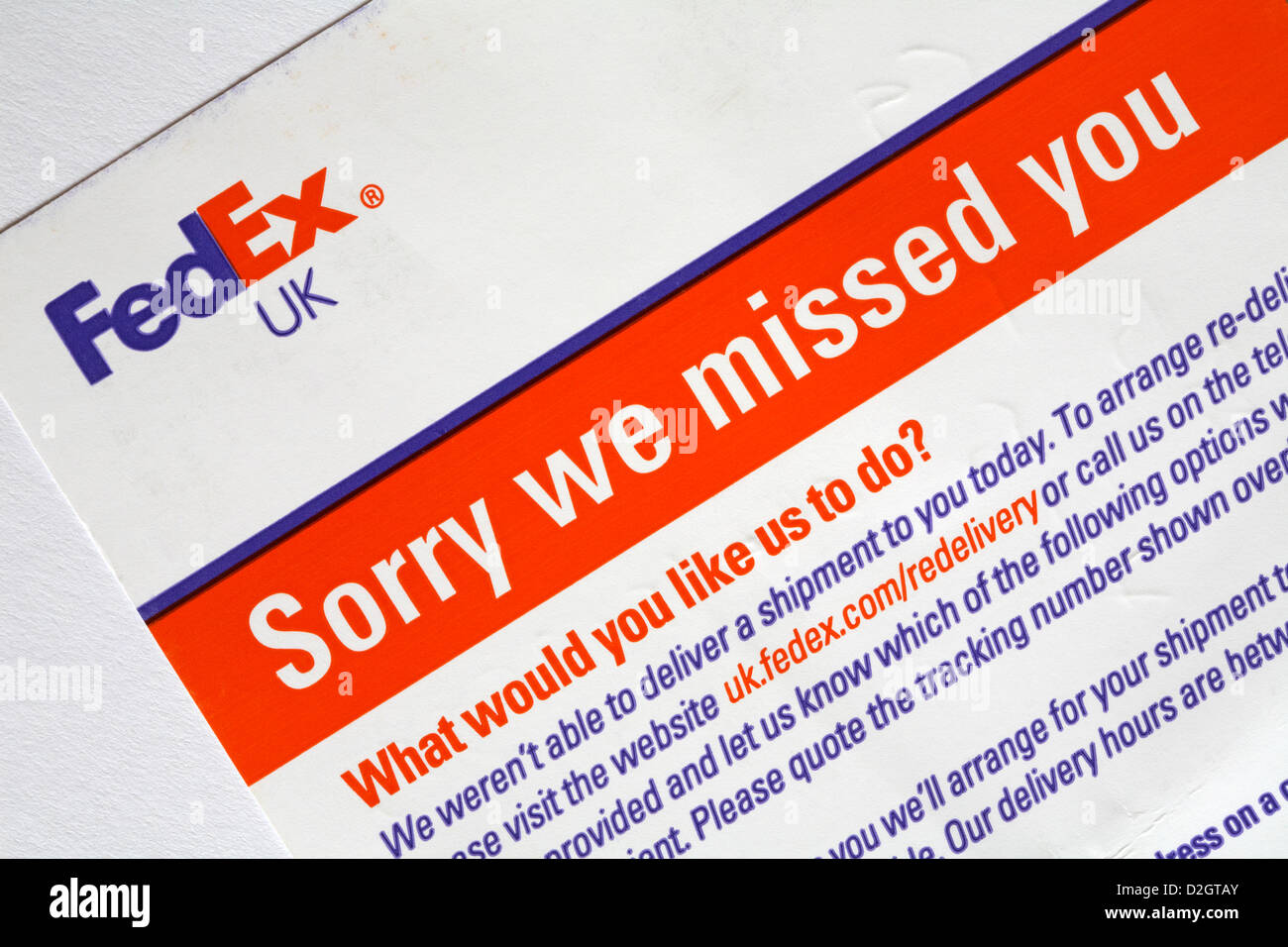 FedEx UK sorry we missed you card - what would you like us to do? card left by FedEx courier as no one home to receive parcel package mail Stock Photo