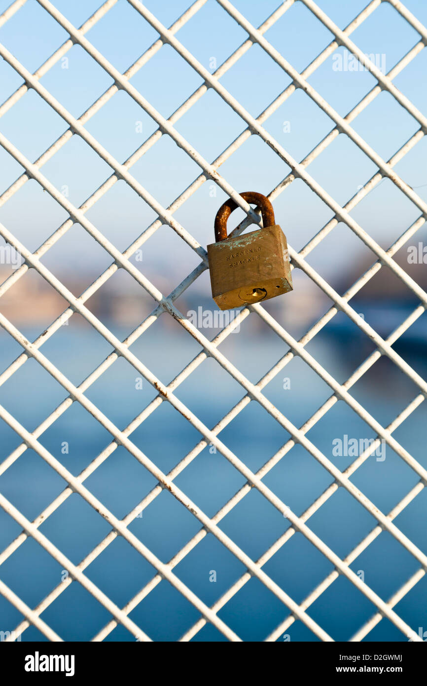 One single padlock, known as a love lock or lovelock, attached to a