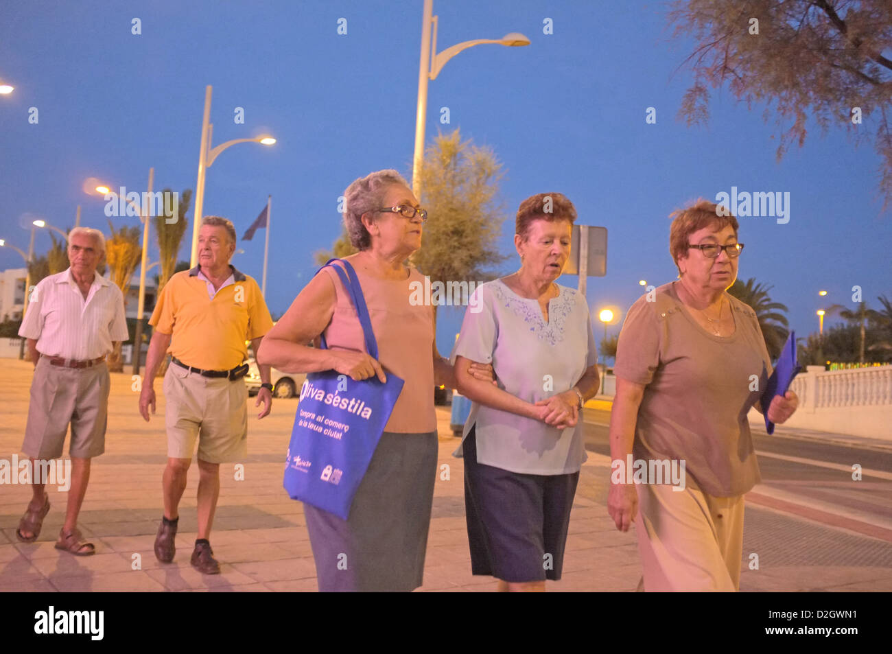 Spanish families on an evening stroll Stock Photo