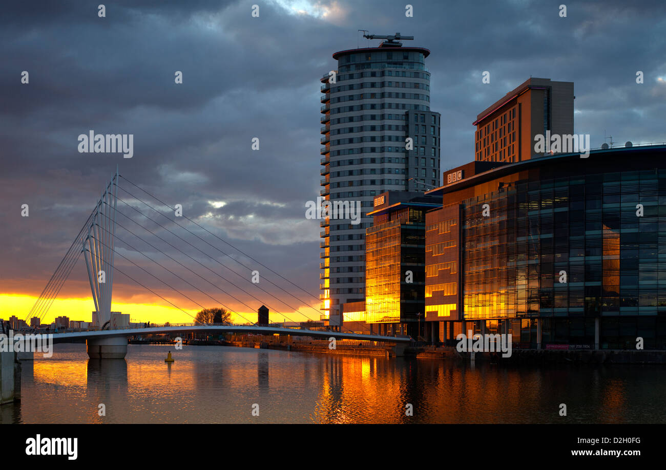 England, Greater Manchester, Salford quays, Setting sun reflected in
