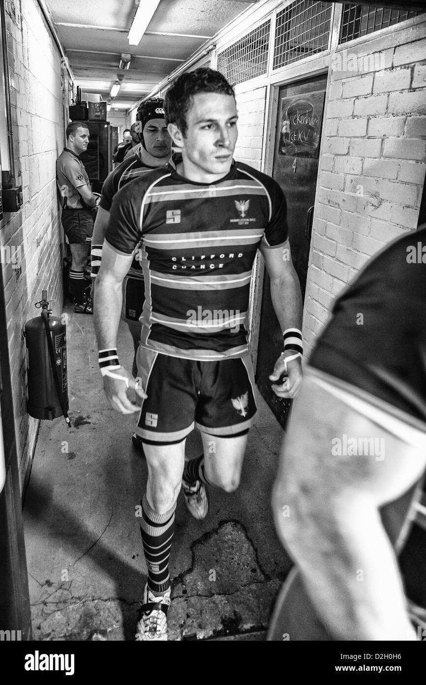 Rugby player walks out of dressing room down a corridor to the pitch. Stock Photo