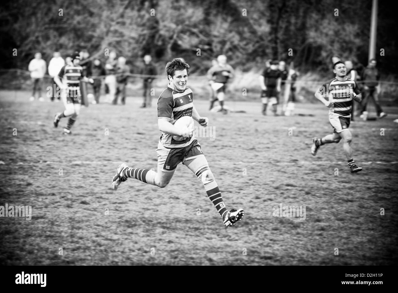 Rugby player running with the ball. Stock Photo