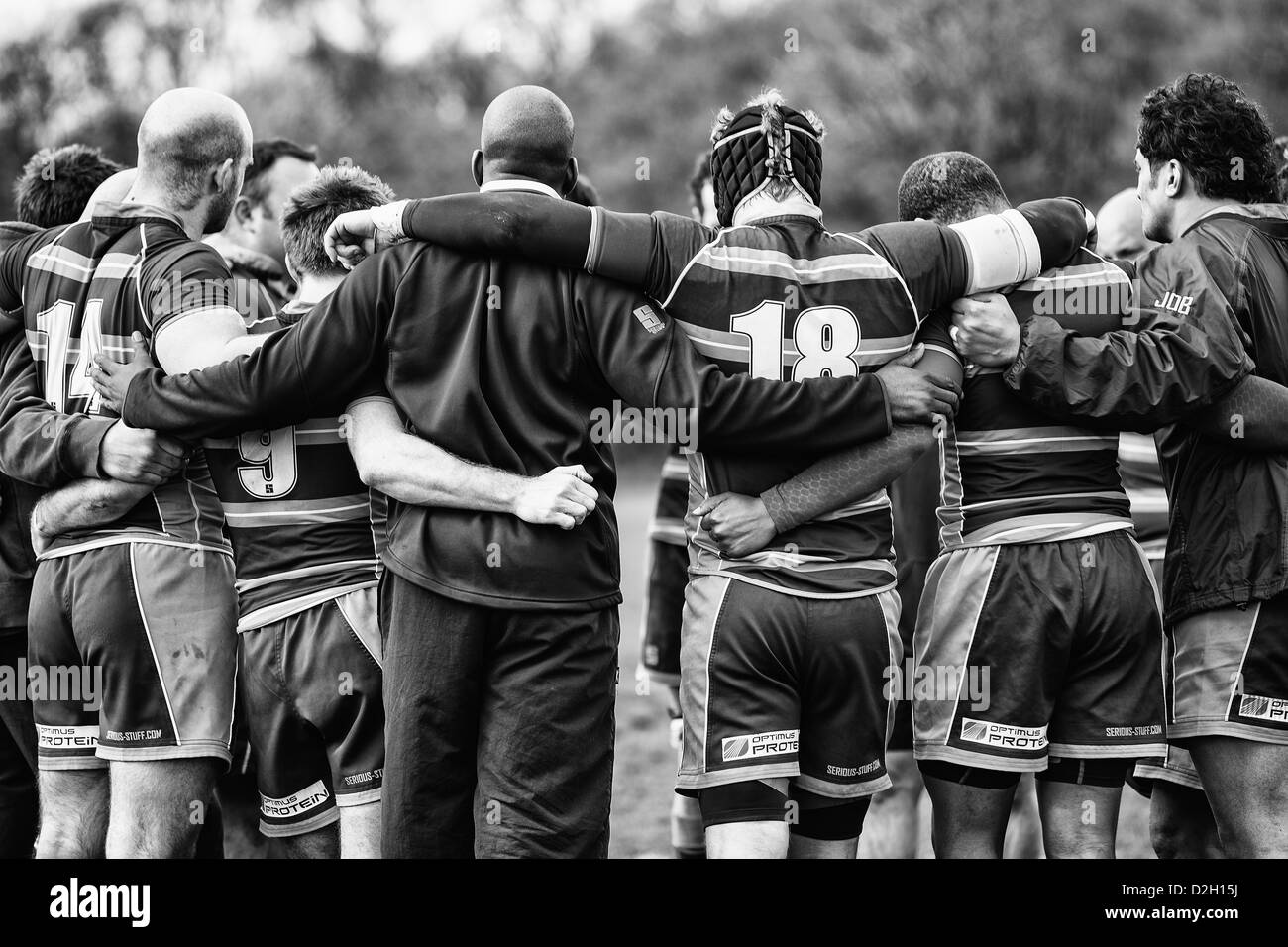 A team of rugby players huddle after a match Stock Photo