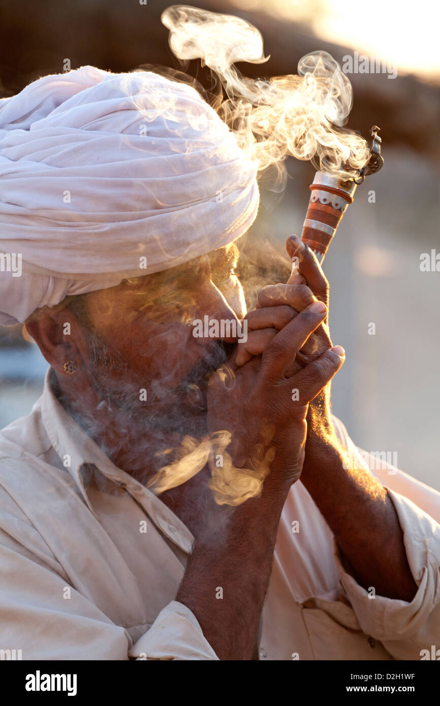 India, Rajasthan, Jodhpur, tribesman smoking opium Stock Photo