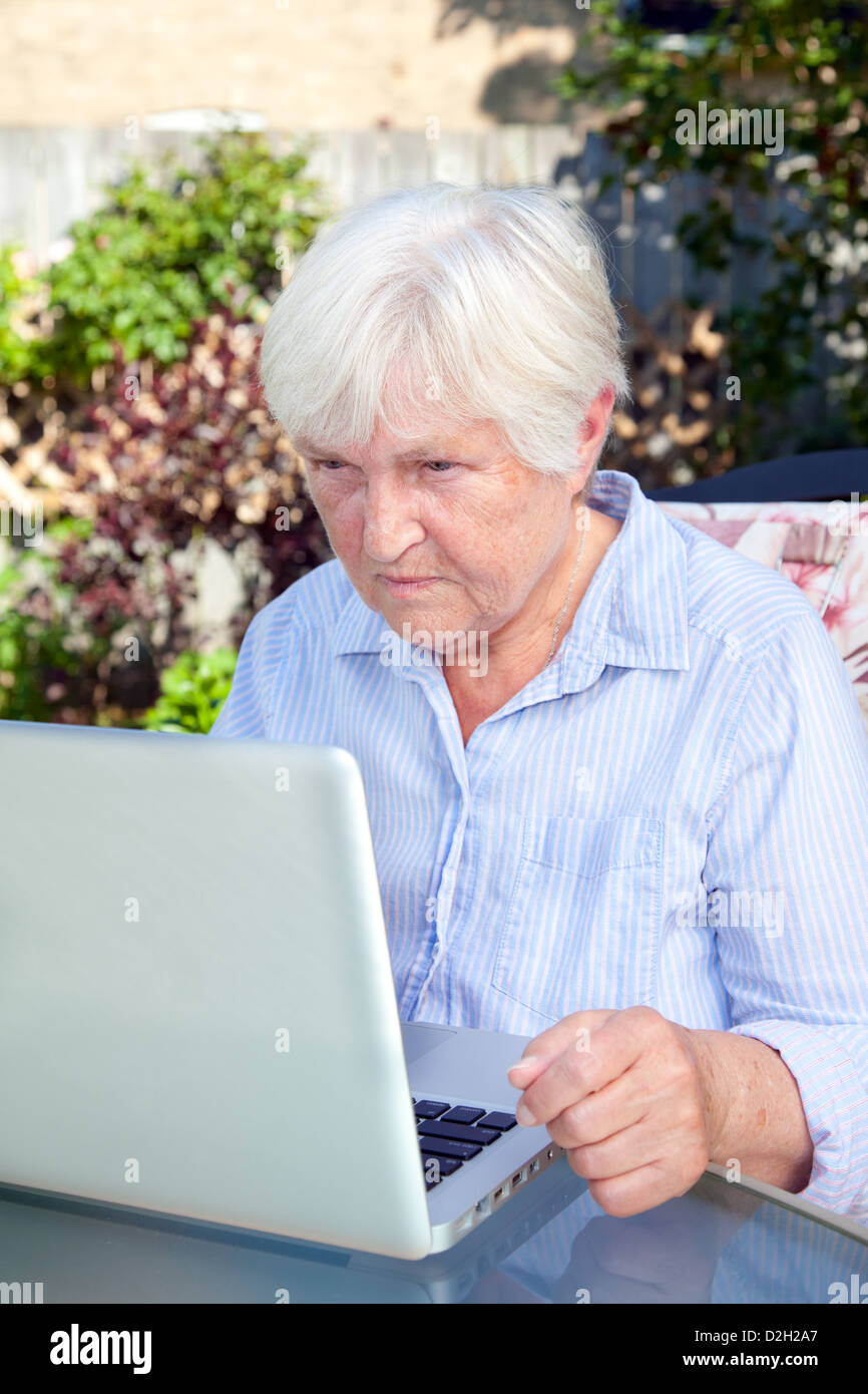 A senior woman working on her laptop computer Stock Photo - Alamy