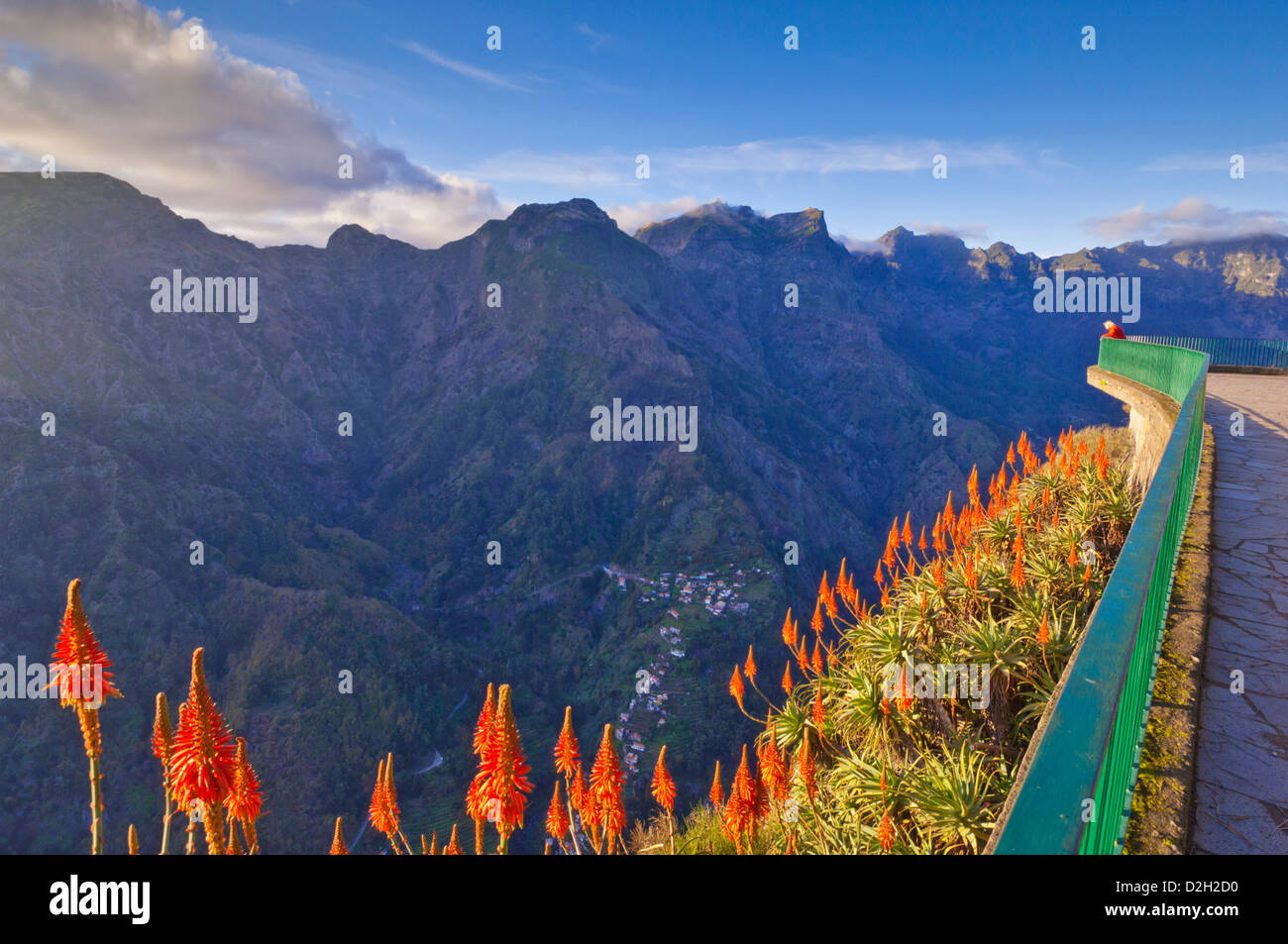 Tourist standing at the Eira do Serrado viewpoint overlooking the village of Curral Das Freiras or Valley of the Nuns Madeira Portugal EU Europe Stock Photo