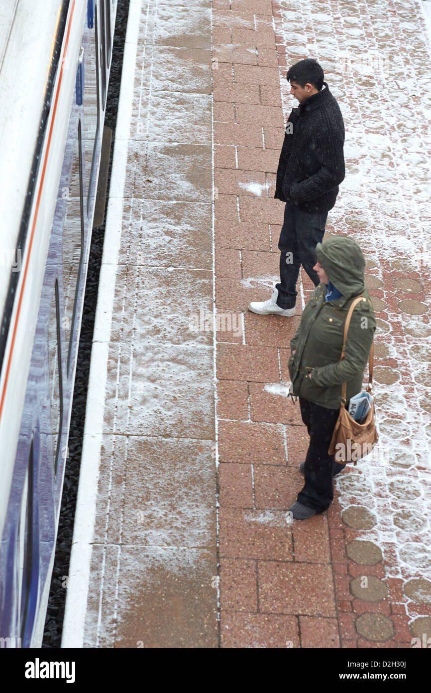 Commuters wait in the snow for a train at Stoke Mandeville station