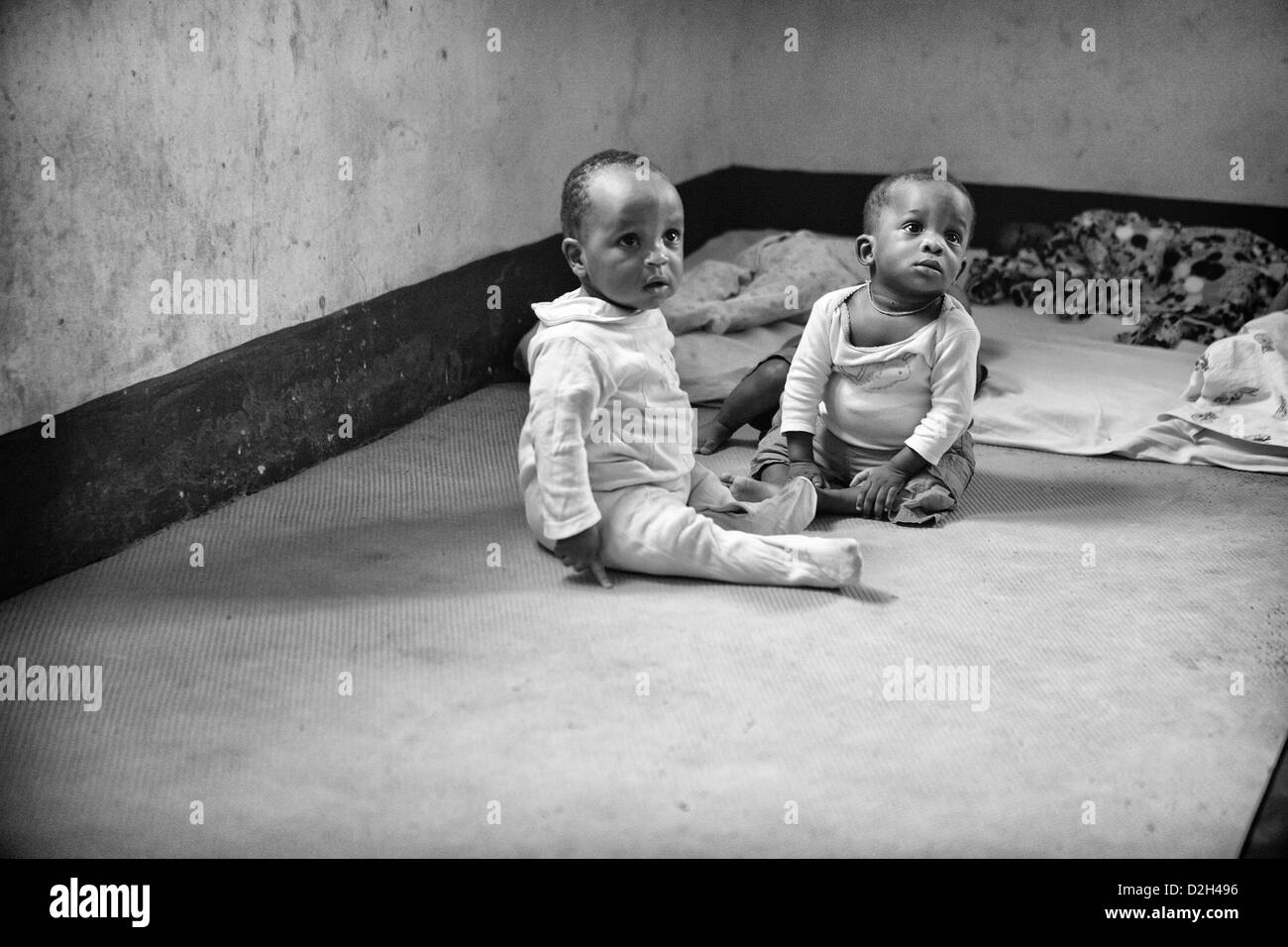 Two small children at a babies home in Uganda. Both of these children had been abandoned at birth. Stock Photo