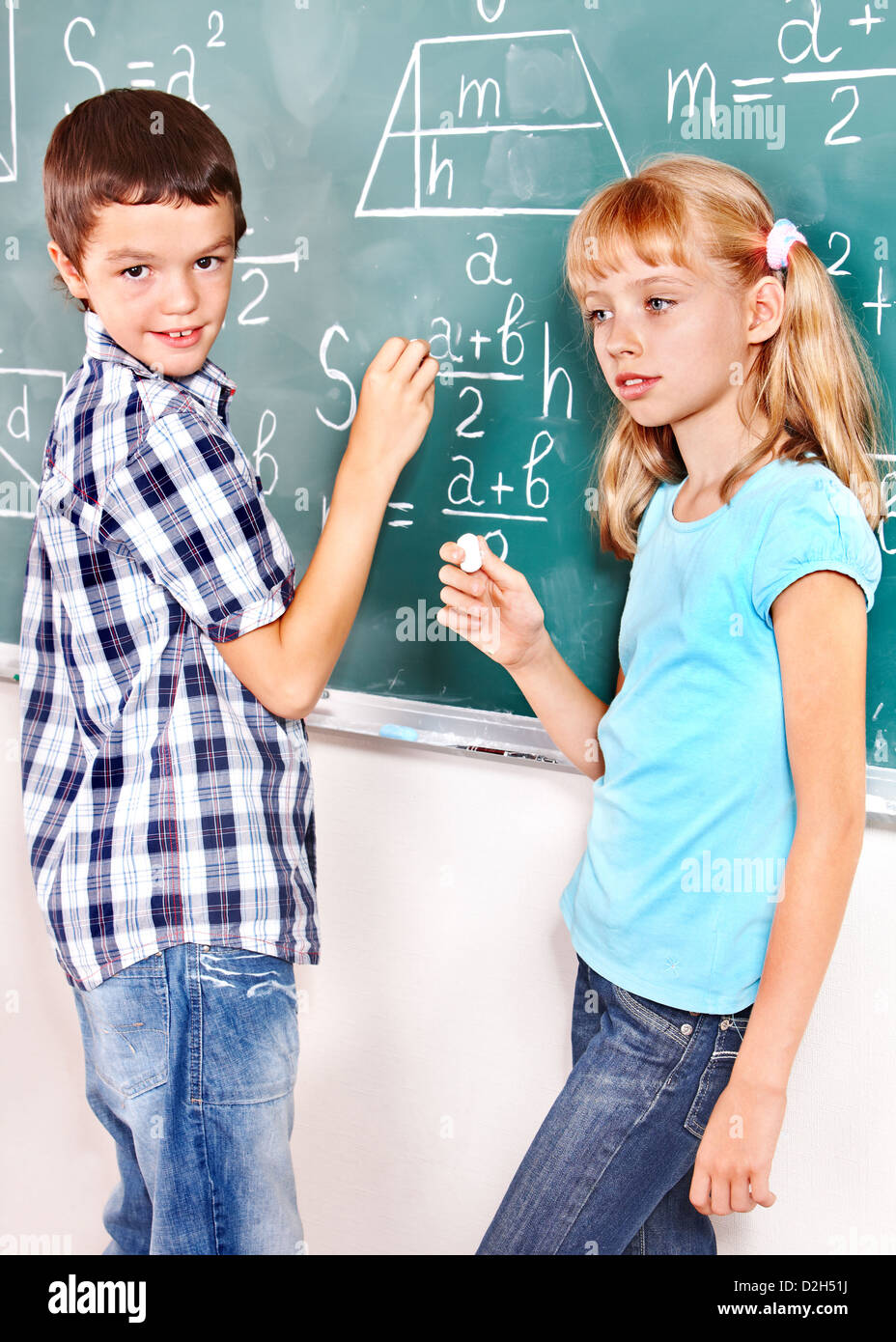 Teen school child sitting on desk in classroom Stock Photo - Alamy