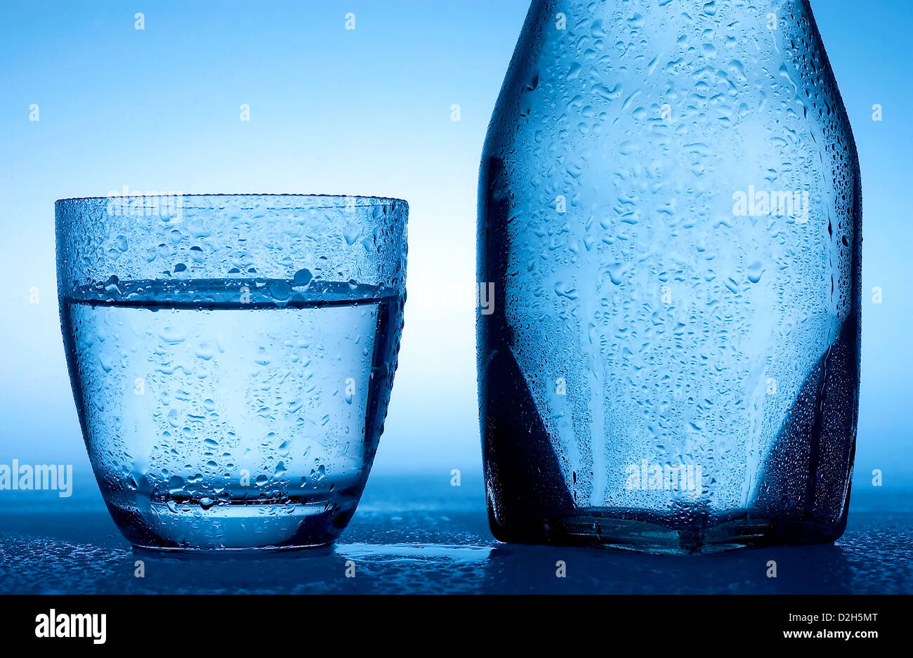 Glass and bottle with water. Stock Photo