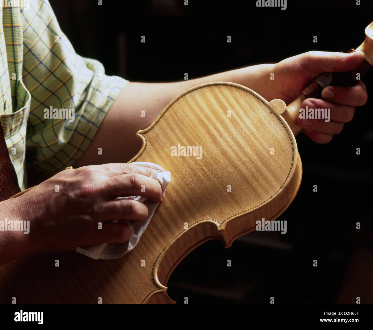 Violin maker luthier polishing violin Stock Photo Alamy