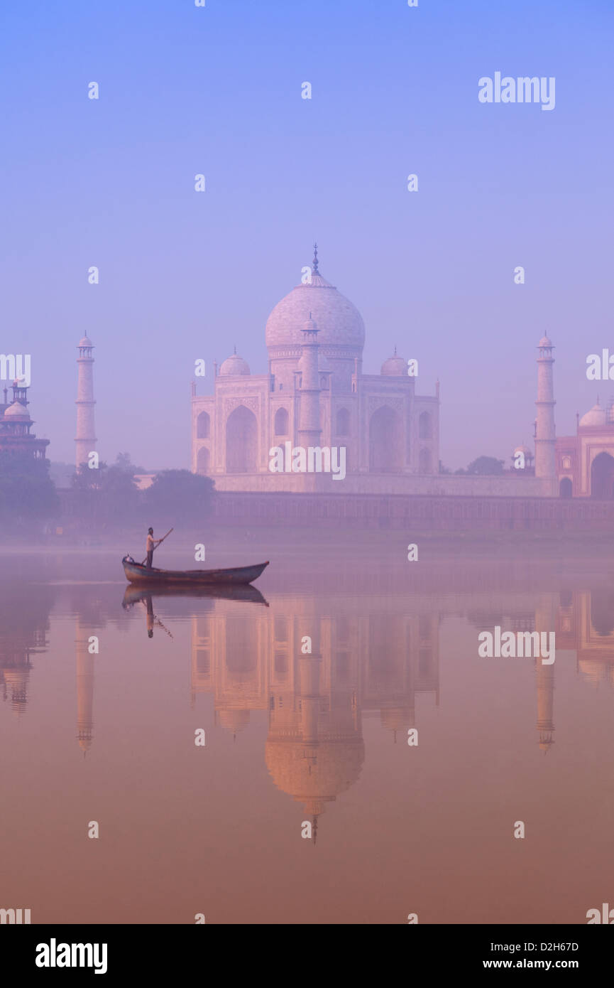 India, Uttar Pradesh, Agra, Taj Mahal and boatman on River Yamuna at dawn Stock Photo
