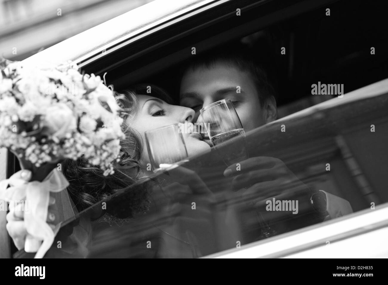 Newly-married couple in car with champagne Stock Photo - Alamy