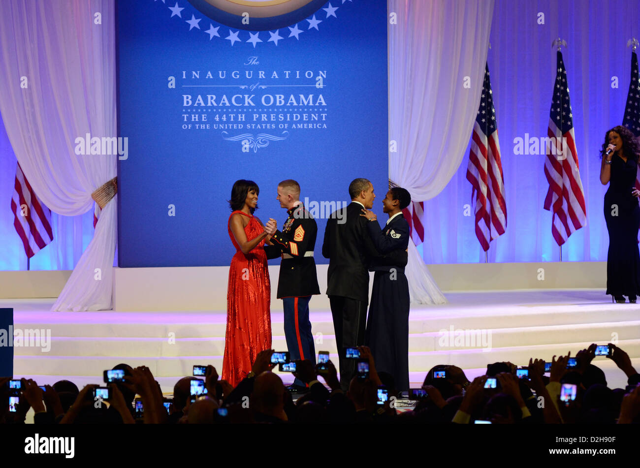 US President Barack Obama dances with Air Force Staff Sgt. Bria Nelson as First Lady Michelle Obama dances with Gunnery Sgt. Timothy Easterling at the Commander in Chief's Ball January 21, 2013 at the Washington Convention Center in Washington, DC. Stock Photo