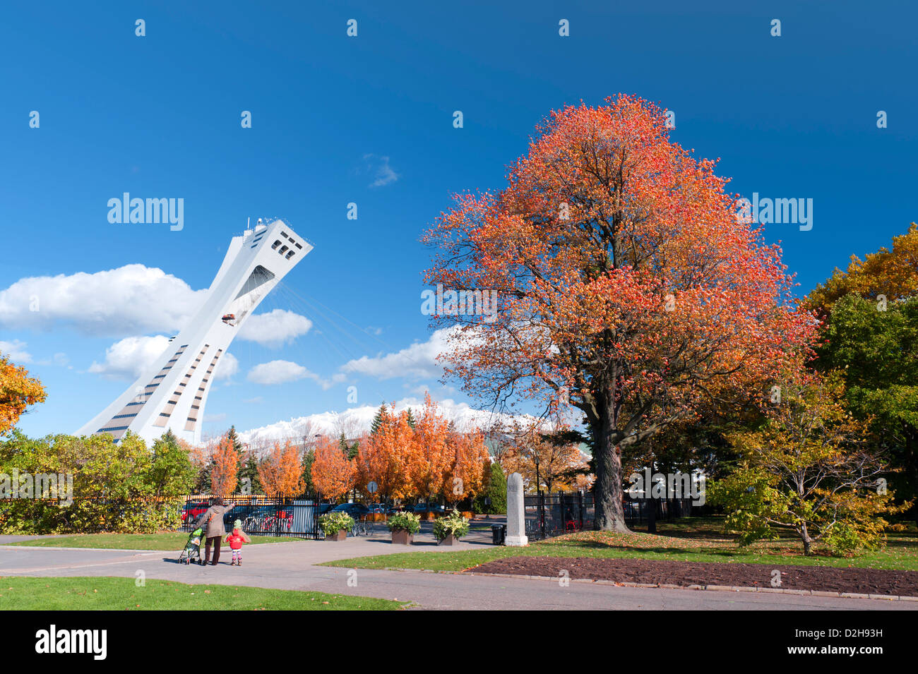 Woman and child on the grounds of Montreal Botanical Garden in autumn, with the Olympic Stadium in the background. Stock Photo
