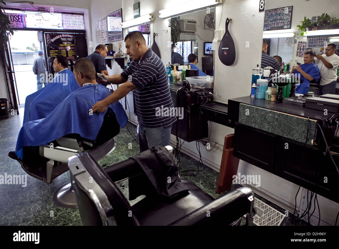 young hispanic locals getting haircuts at Oaxaca barber shop ON La