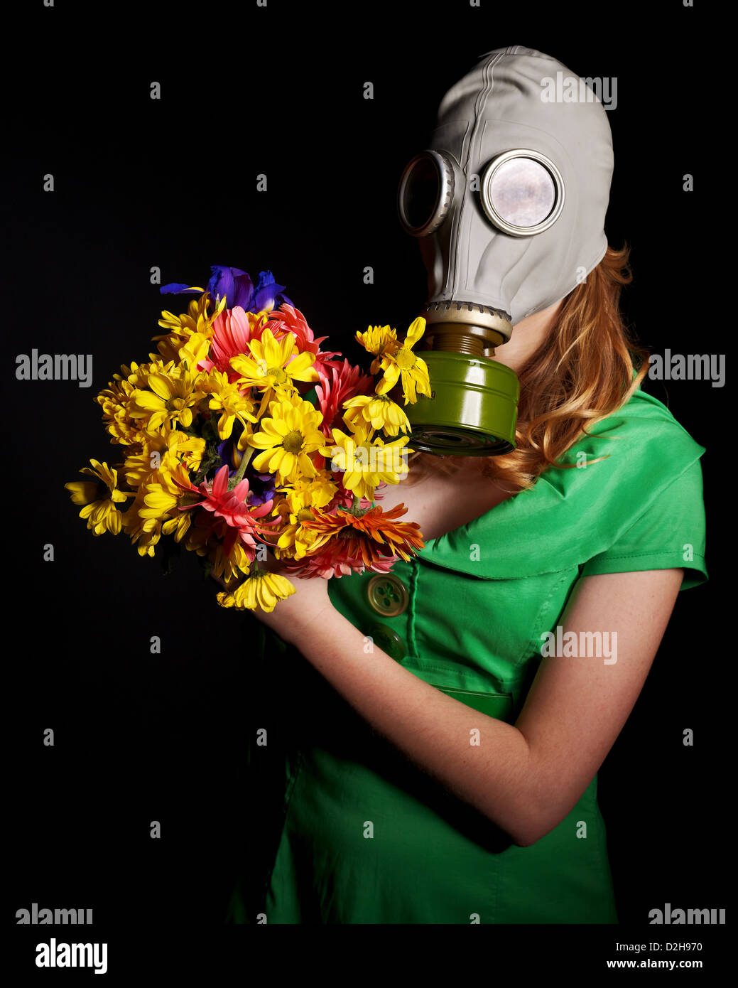 Woman holding flowers and gas mask Stock Photo - Alamy