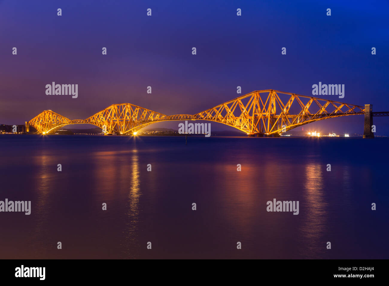 Forth Rail Bridge floodlit under the early evening light, taken from South Queensferry Stock Photo