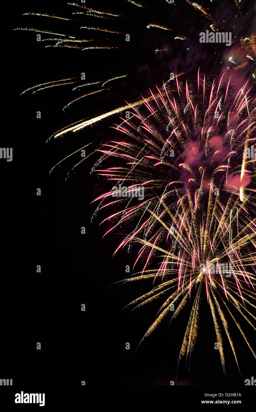 Fireworks explosions against the night sky in holiday celebration, a