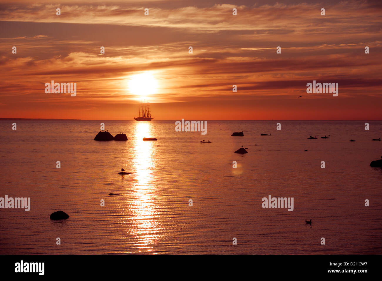 Sea sunset on fire with sail ship frigate silhouette Stock Photo