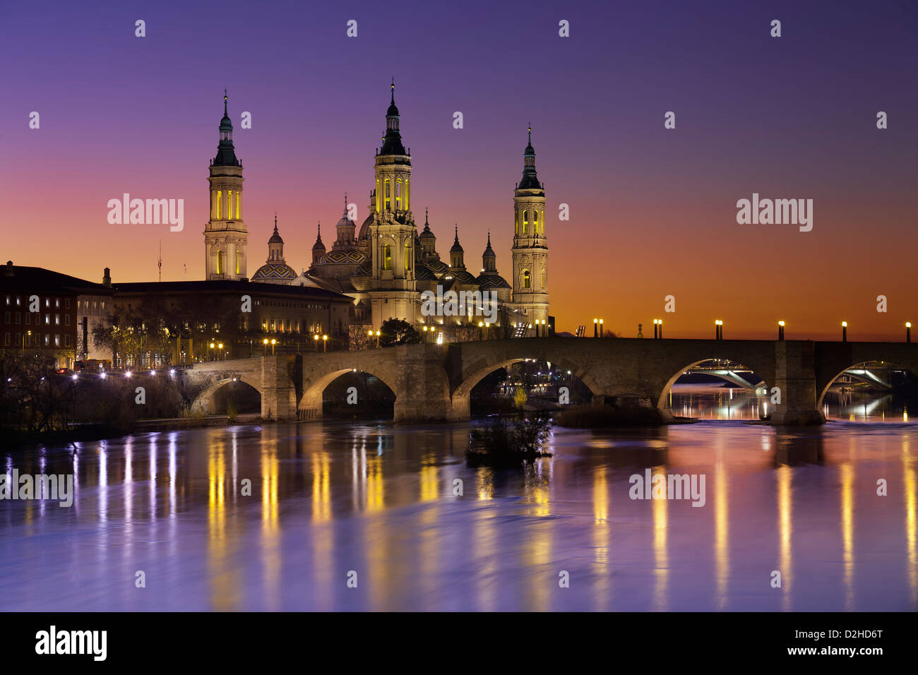 Basilica ' El PIlar' ant the roman bridge over Ebro river at dusk.Zaragoza.Spain. Stock Photo