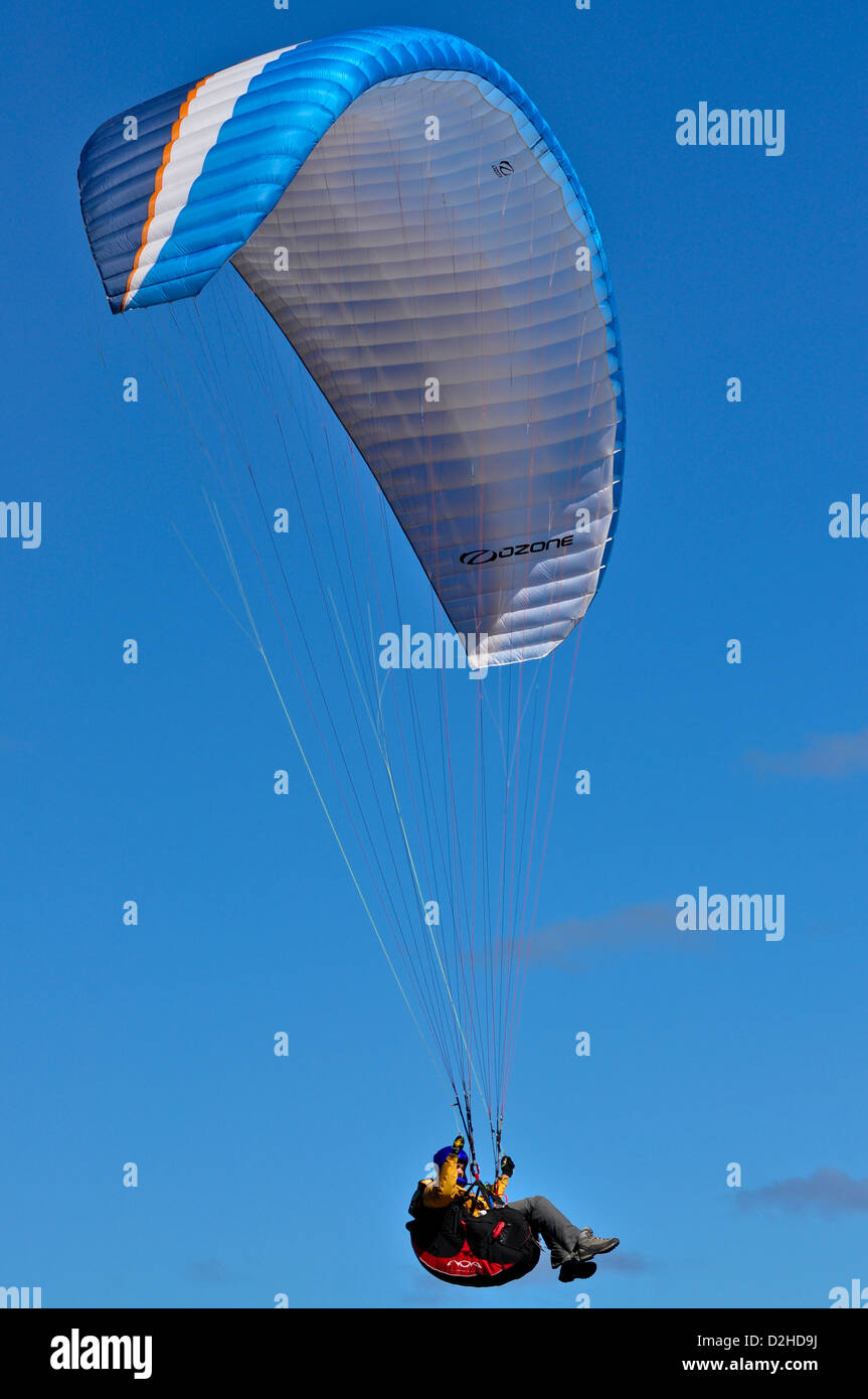 Man parasailing over a beach on the Great Ocean Road near Lorne in Victoria Australia Stock Photo