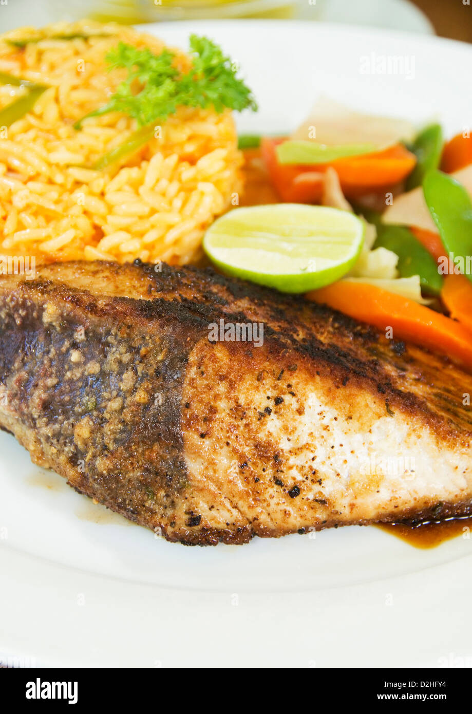 fresh Caribbean style yellowfin tuna steak with vegetables rice as photographed in Union Island St. Vincent and the Grenadines Stock Photo