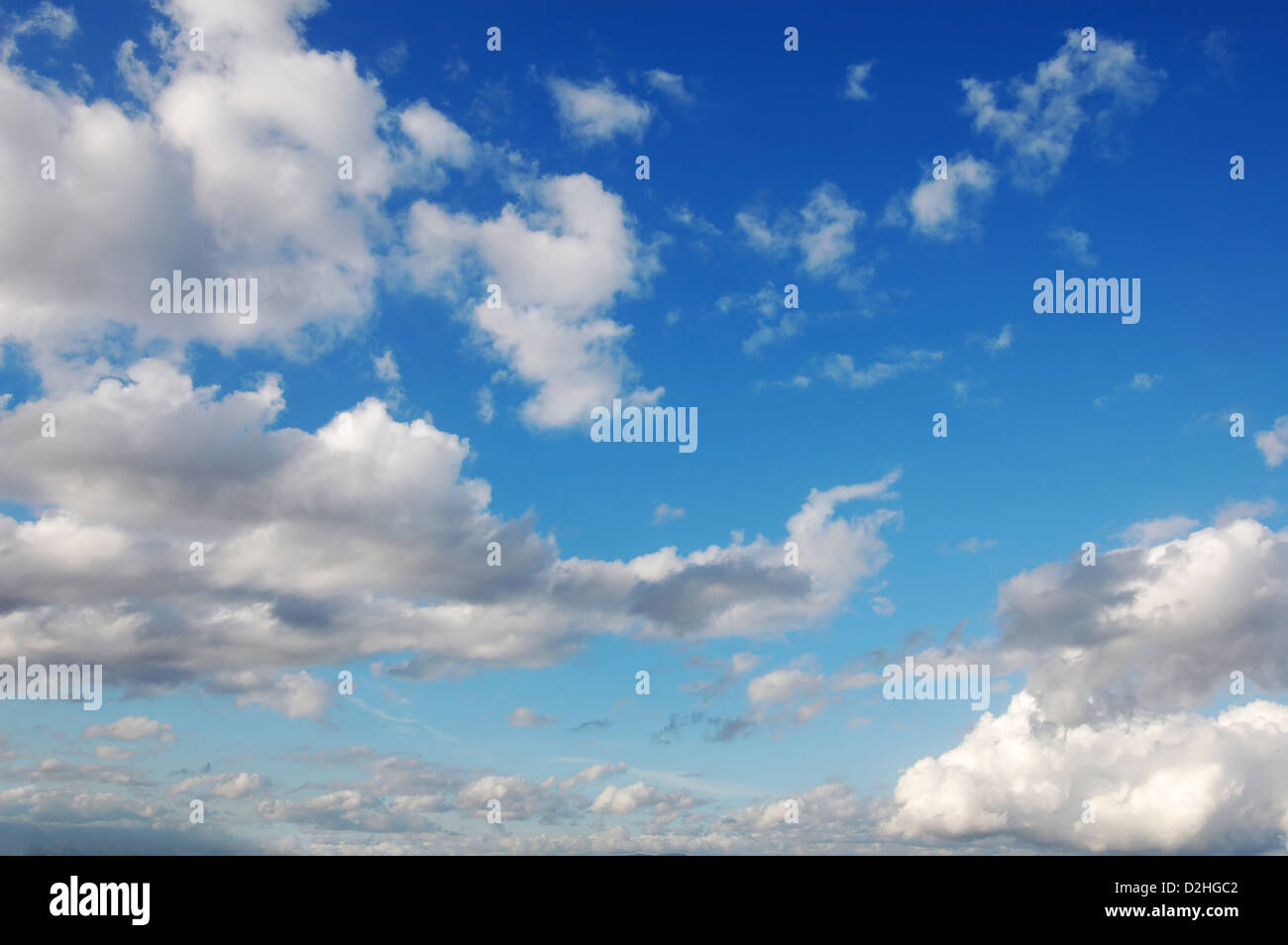 Blue sky with several cumulus white clouds. Stock Photo
