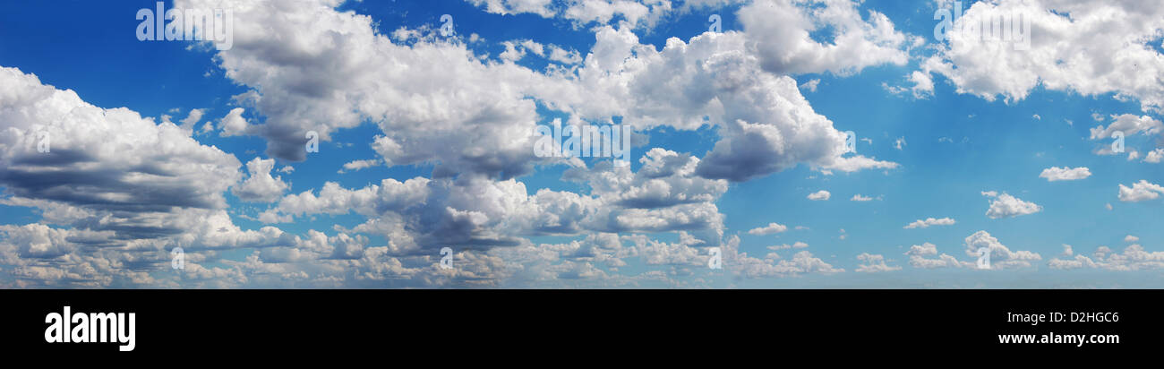 Blue sky with many cumulus fluffy white clouds. Very wide format. Stock Photo