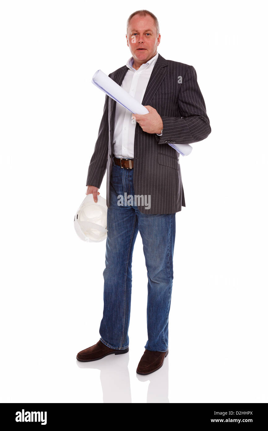 An architect or Surveyor wearing a jacket and jeans holding building plans and hard hat helmet, isolated on a white background. Stock Photo