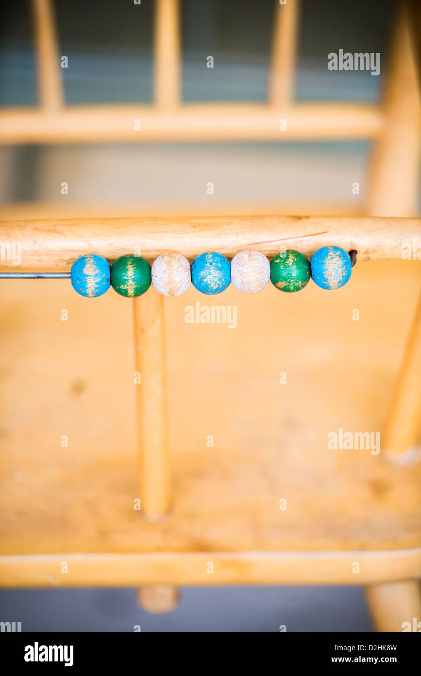 High chair used for small children with wooden pebbles used for counting Stock Photo