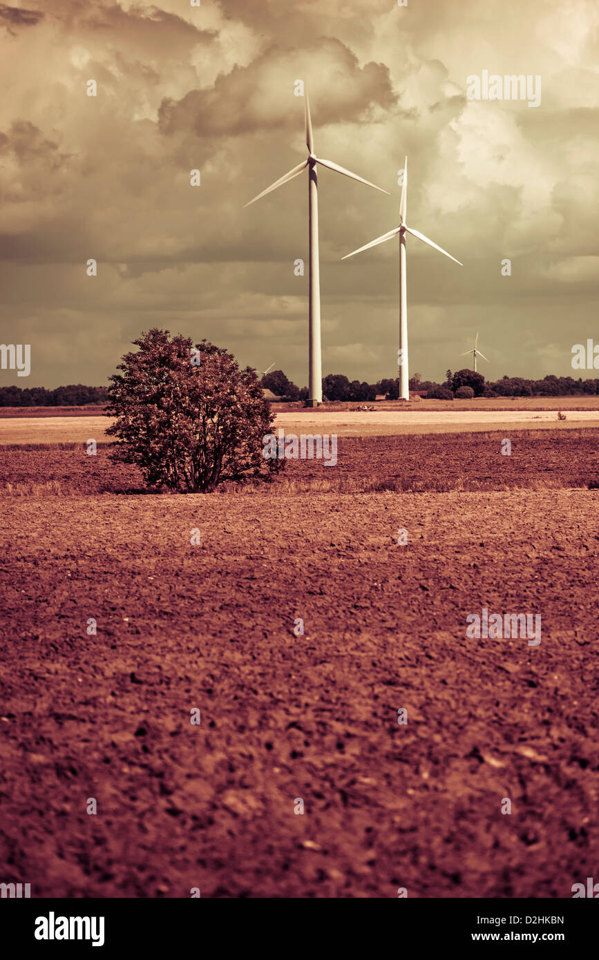 Modern windmills generating electricity in rural landscape Stock Photo