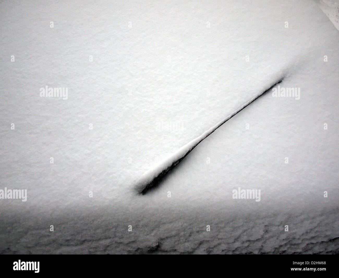 rear windscreen wiper on a car covered with snow Stock Photo