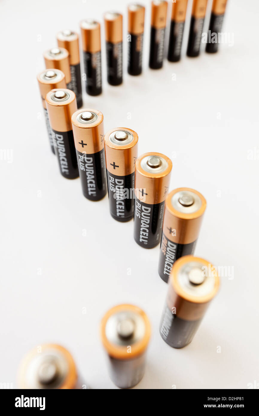 Bath, United Kingdom - November 16, 2011: A curved line of Duracell Plus AA batteries standing on a plain background. Stock Photo