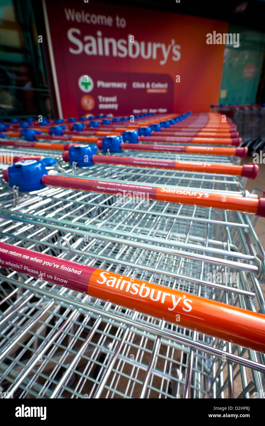Bath, United Kingdom - April 24, 2011: A line of branded Sainsbury's shopping trolleys outside a Sainsbury's supermarket in Bath Stock Photo