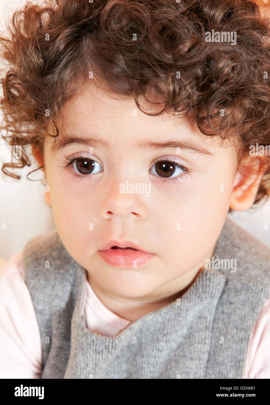 Two year old baby girl with curly hair portrait Stock Photo - Alamy