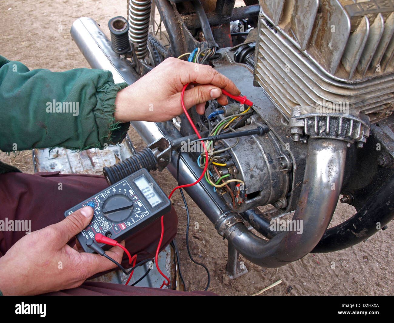 Young man with multimeter testing motorcycle engine Stock Photo Alamy