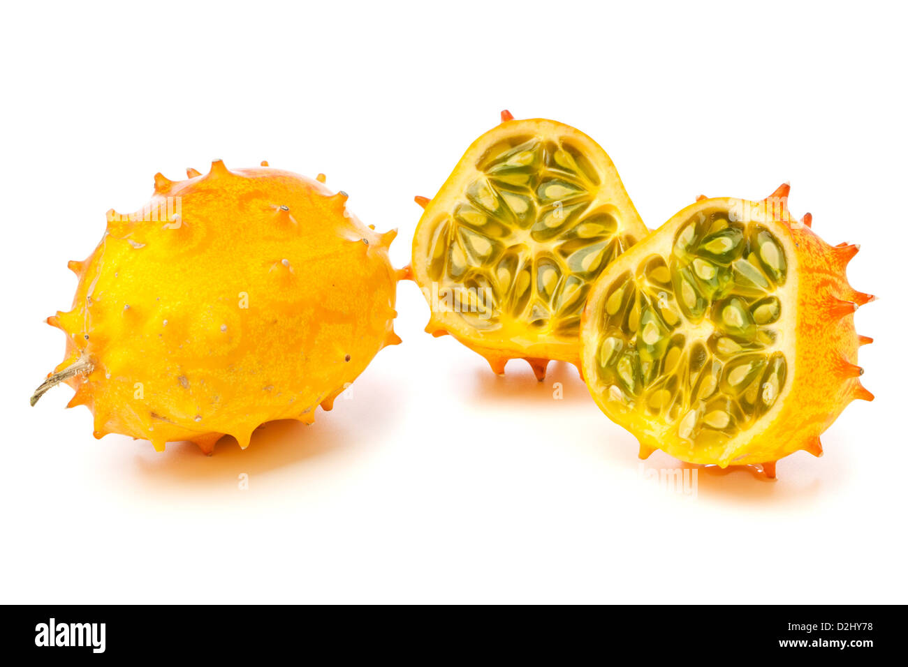 Whole and halved Kiwano fruits, also called African Horned melon or Horned Cucumber, isolated on white background Stock Photo