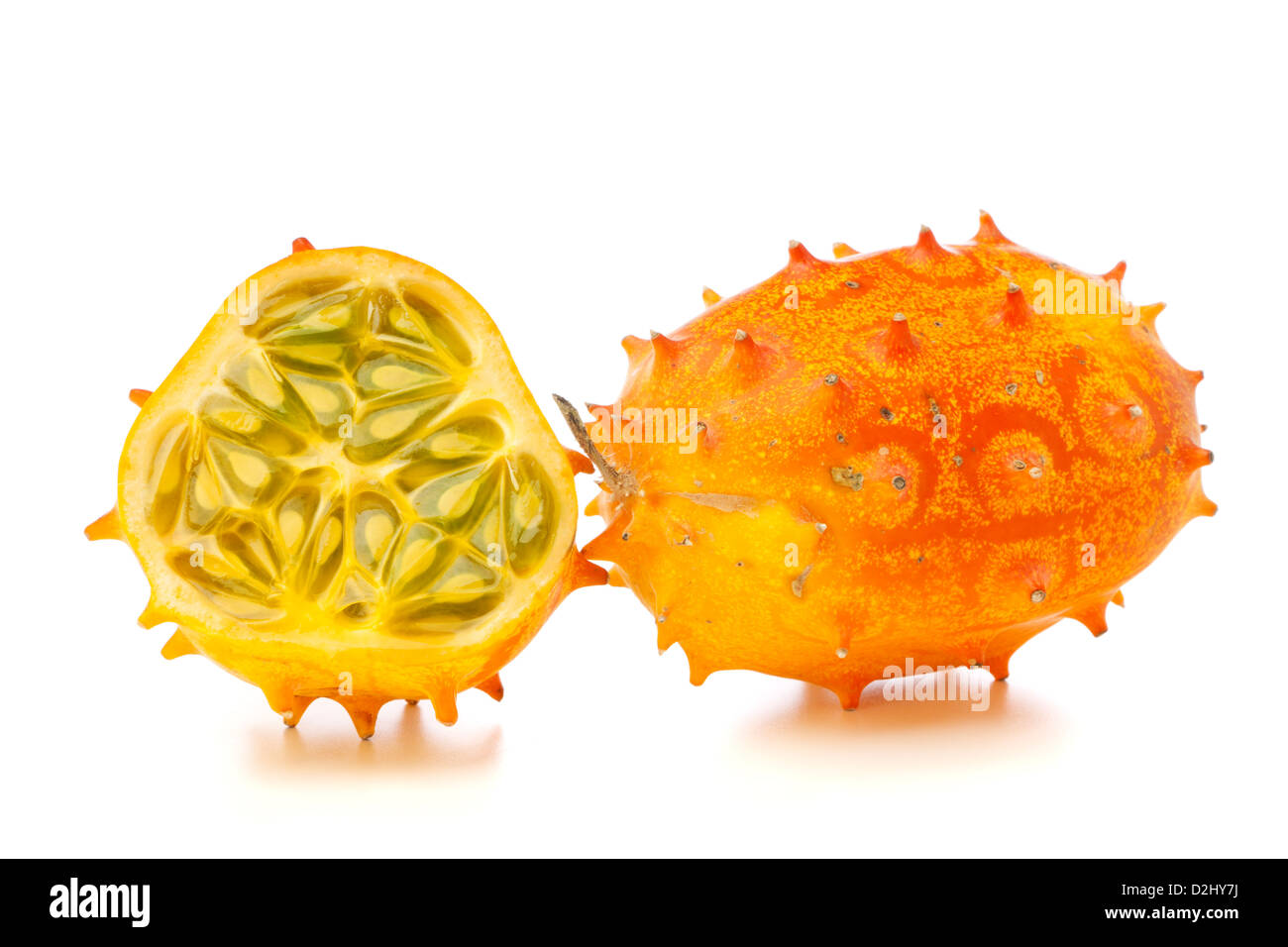 Whole and half Kiwano fruits, also called African Horned melon or Horned Cucumber, isolated on white background Stock Photo