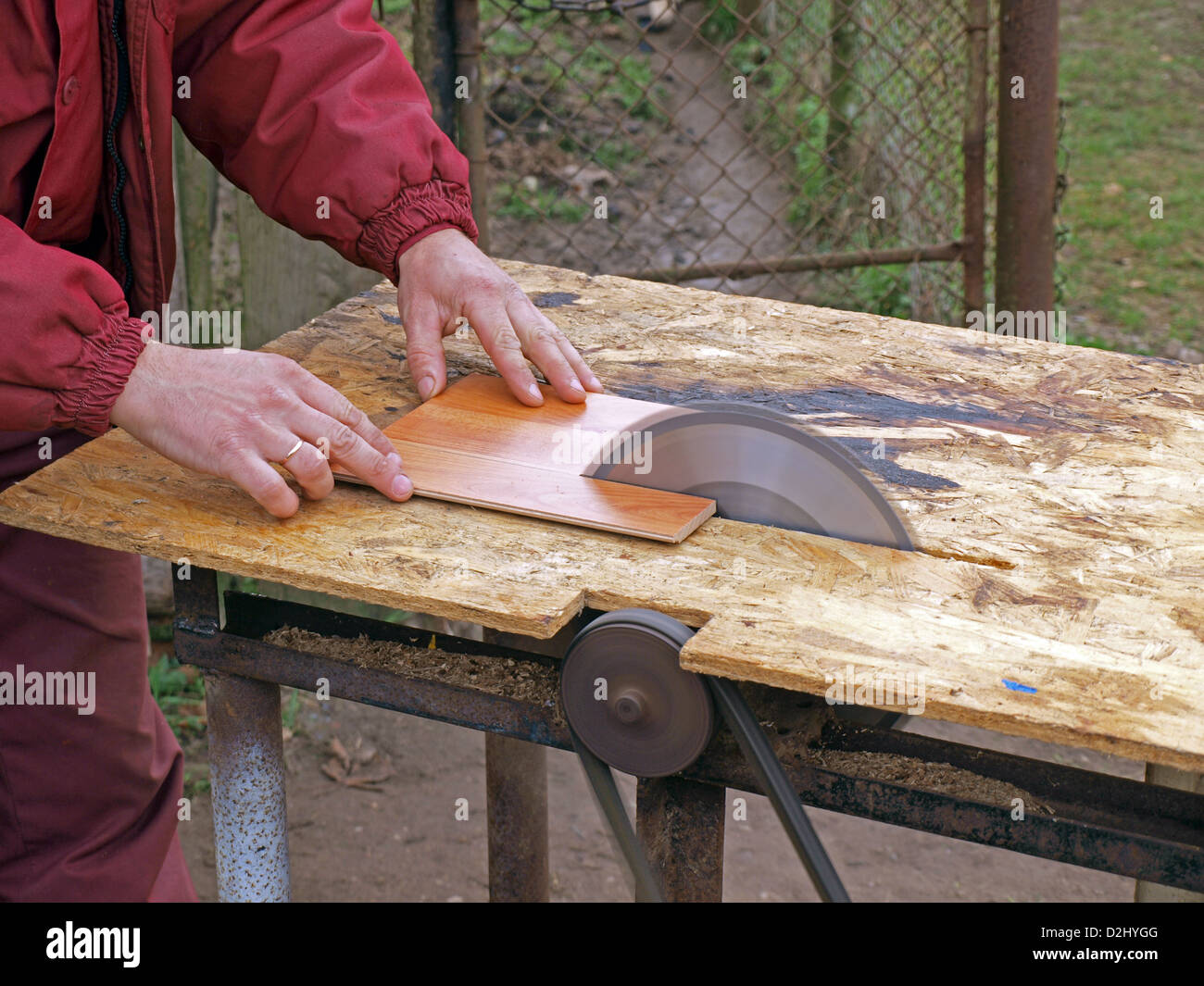 Sawing laminate floorboards by homemade circular saw Stock Photo