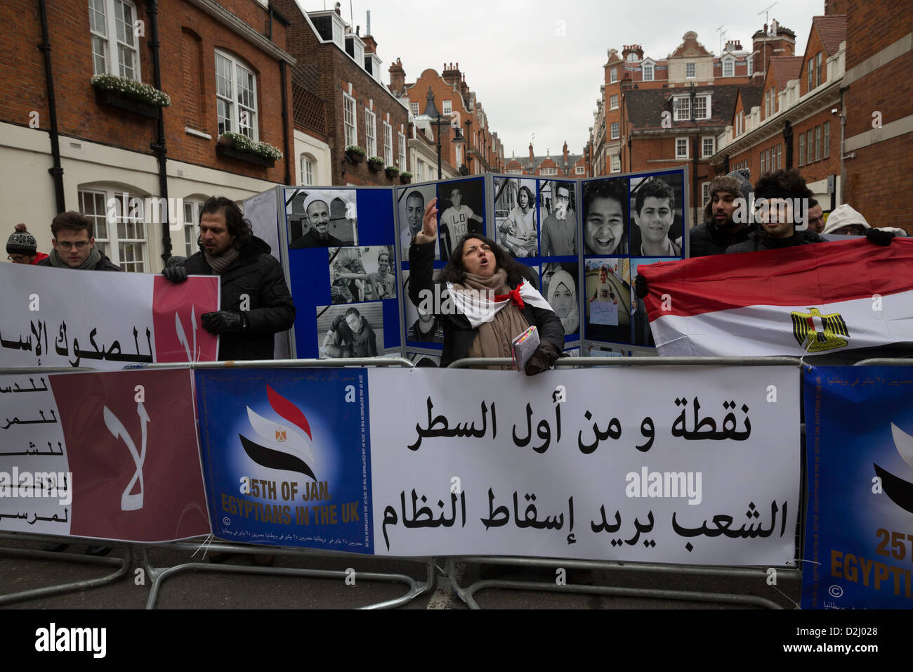 Protesters with banners and pictures of the revolution outside the Egyptian Embassy in London mayfair Stock Photo