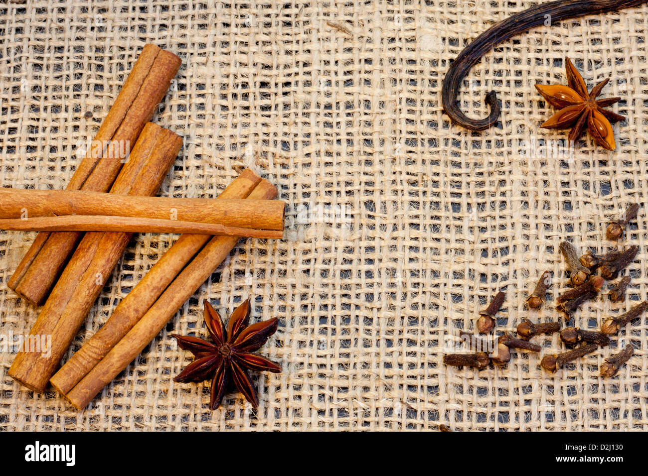 Aroma spices cinnamon anise vanilla and cloves on jute Stock Photo