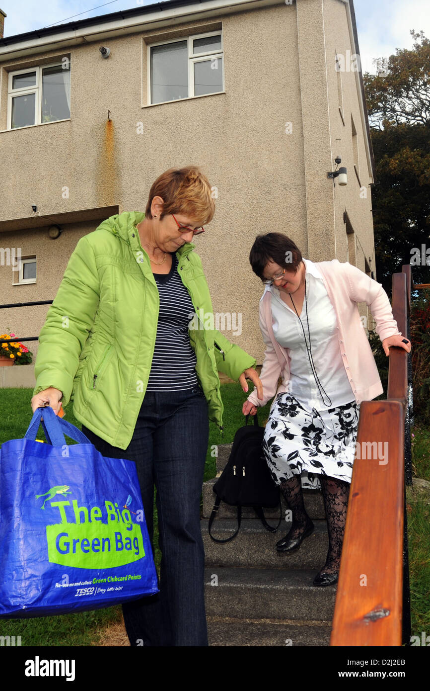 A Young disabled women lives independently with help from her carer, she goes shopping. Stock Photo