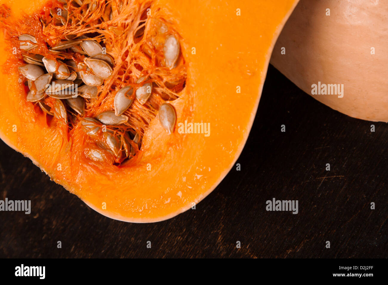 half fresh orange pumpkin on black wooden background Stock Photo - Alamy