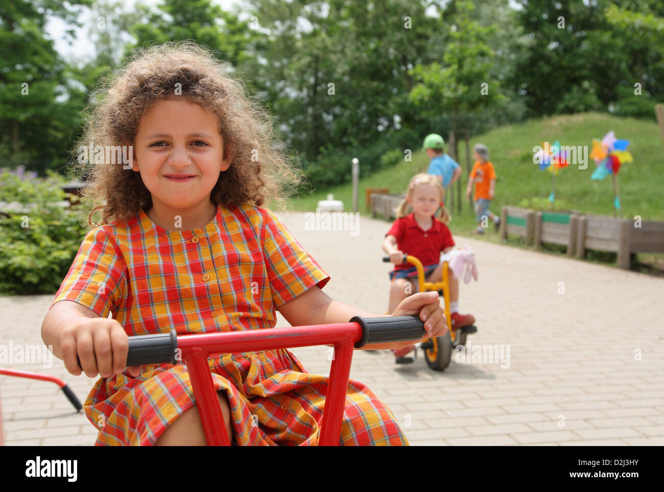 Saarbruecken, Germany, children ride tricycles in a Kindertagesstaette