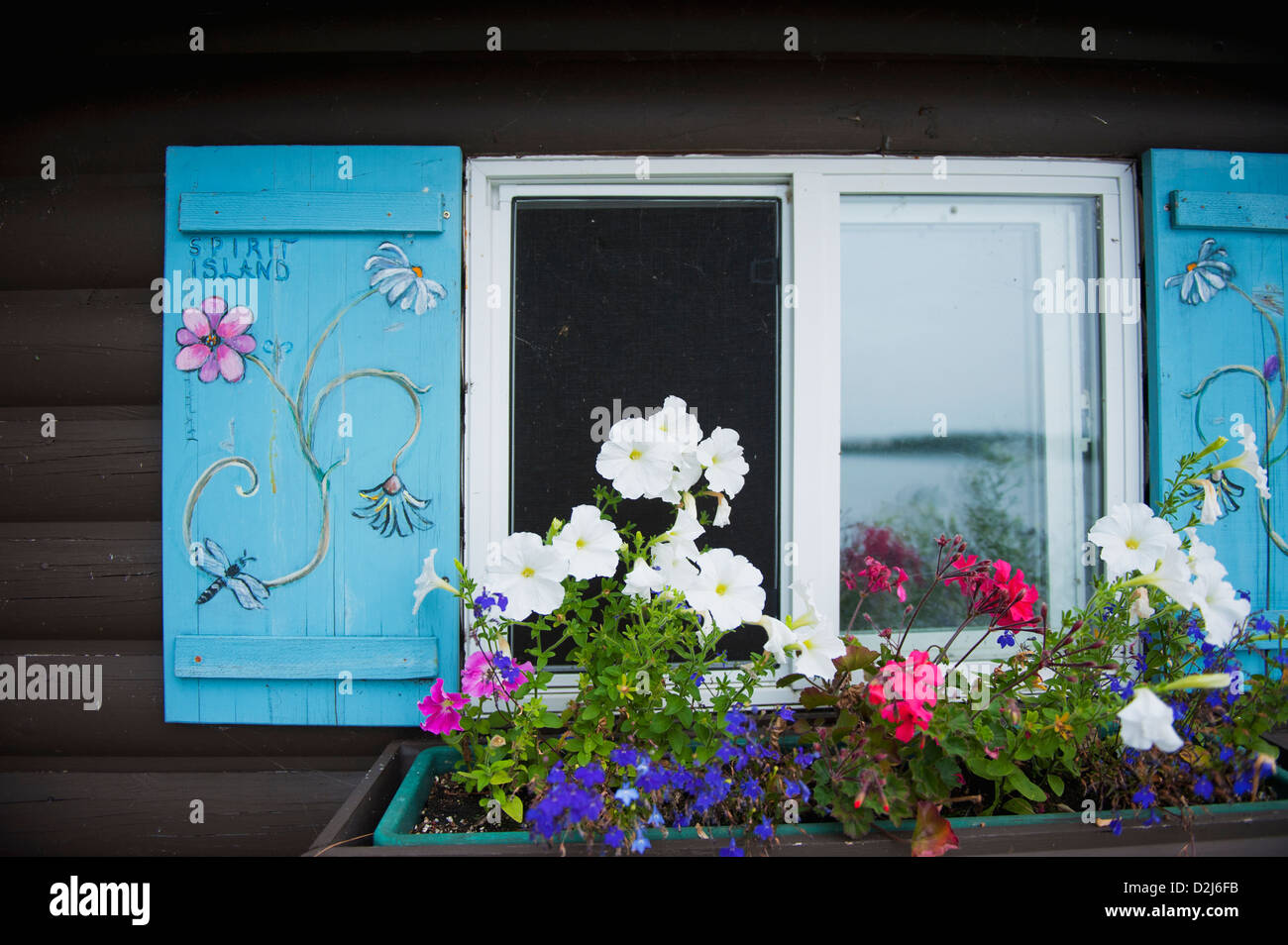 Cabin window with a window flower pot underneath; kenora ontario canada Stock Photo