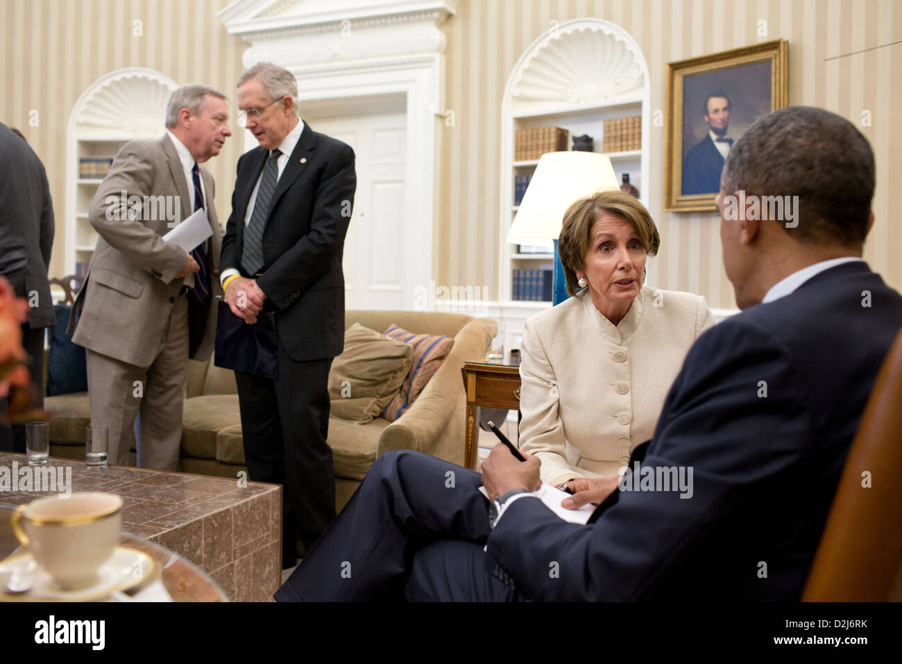 President Barack Obama talks with House Minority Leader Nancy Pelosi following a meeting with Democratic Leadership in the Oval Office, July 11, 2012. At left, Senate Majority Whip Dick Durbin talks with Senate Majority Leader Harry Reid Stock Photo