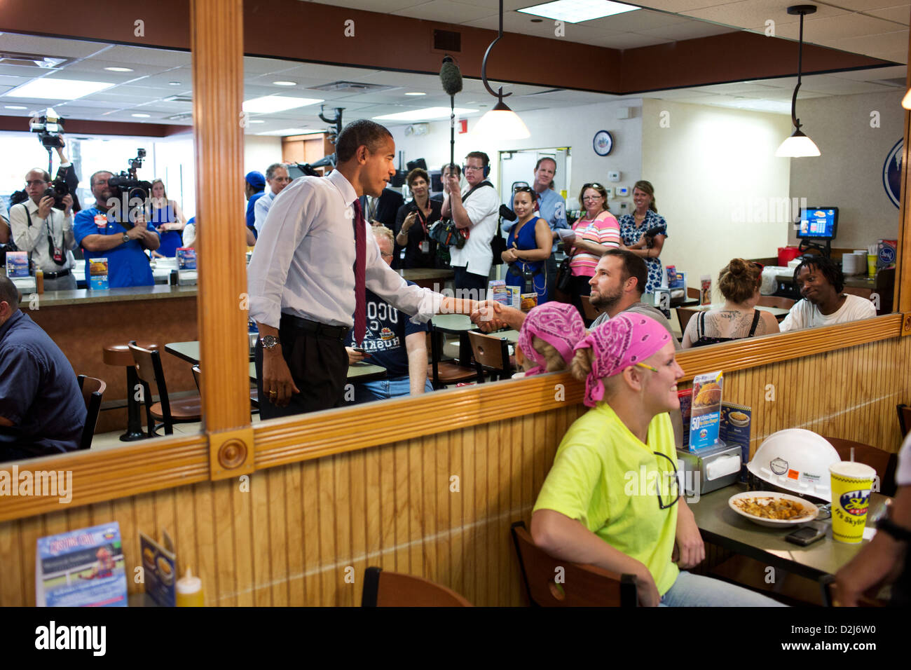 President Barack Obama talks with patrons as he waits for his lunch order during a stop at Skyline Chili July 16, 2012 in Cincinnati, Ohio. Stock Photo