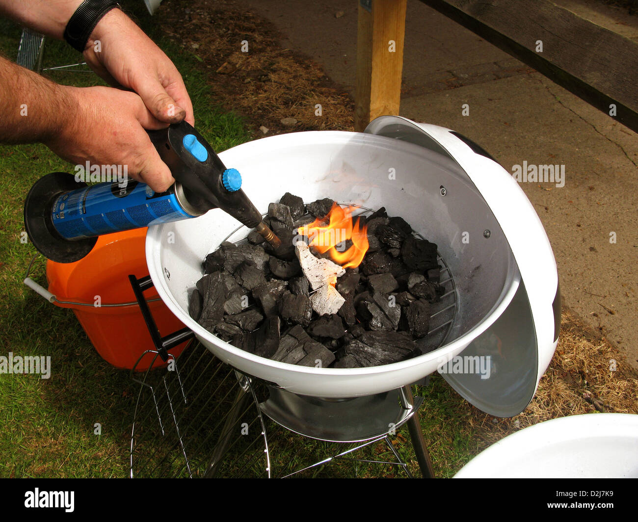 Trying to light a small domestic barbecue with a gas blow torch flame